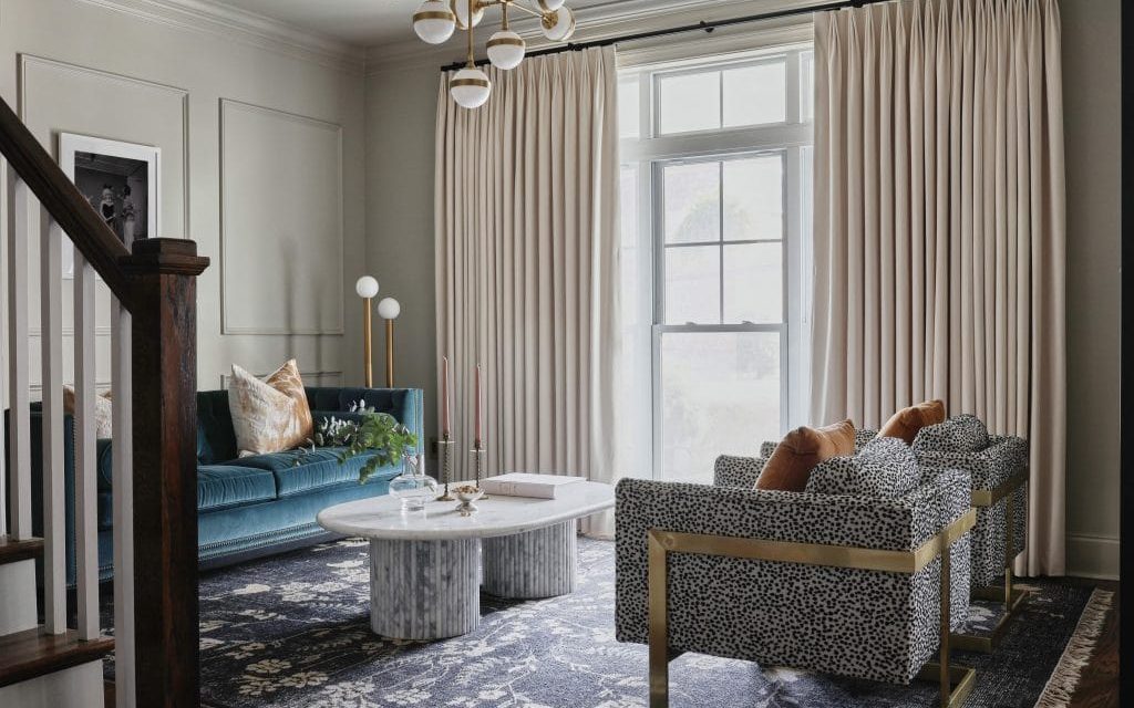 Renovated living room with styled furniture, artwork and warm lighting