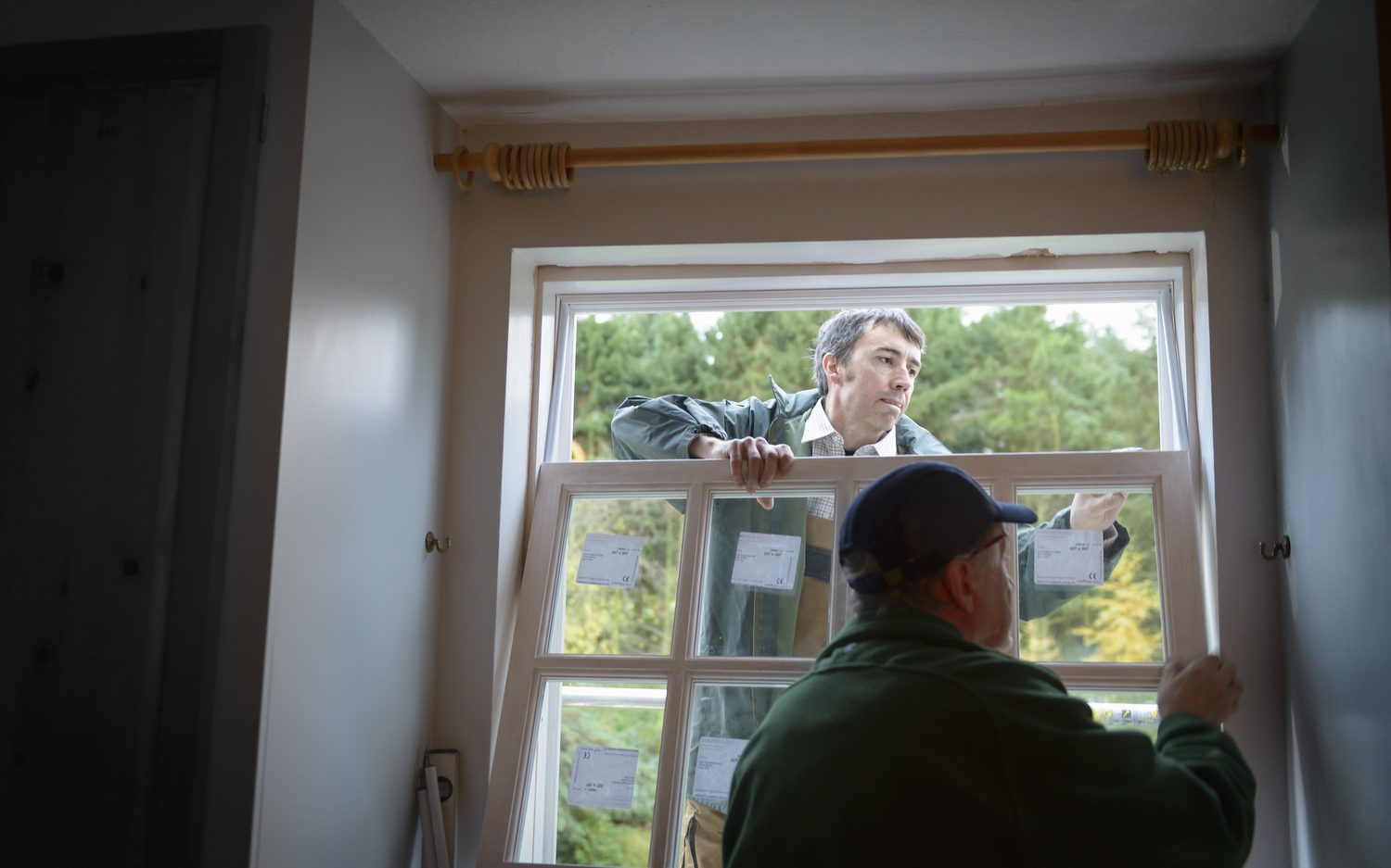 Crew installing replacement windows in a home